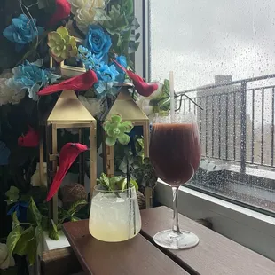 a glass of beverage on a wooden table