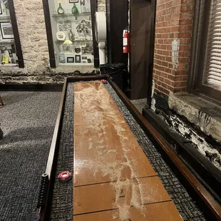 Shuffle board in game room