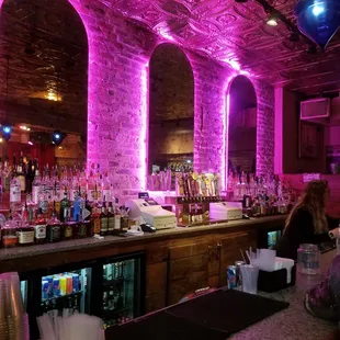 a bar with pink lighting