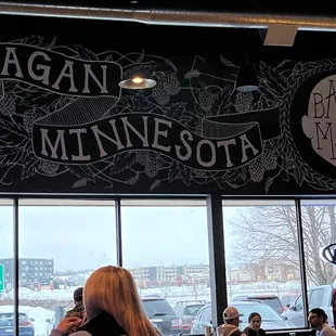 people sitting at tables in a restaurant