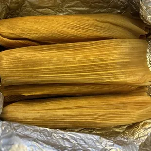 three tamales wrapped in foil