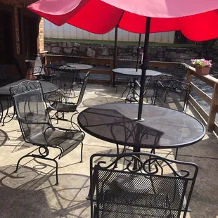 a patio with tables and umbrellas