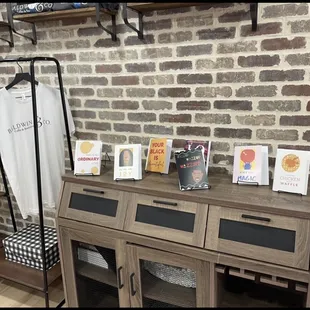 a brick wall and a display of t - shirts