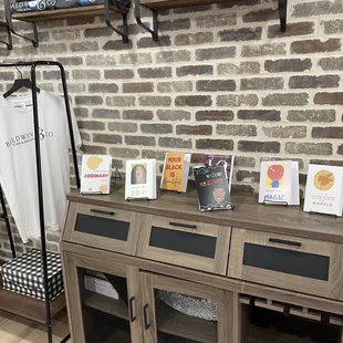 a brick wall and a display of t - shirts