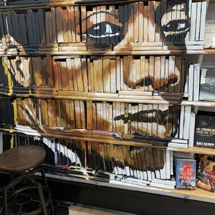 a woman's face painted on a bookcase