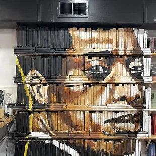 James Baldwin mural painted on book spines.
