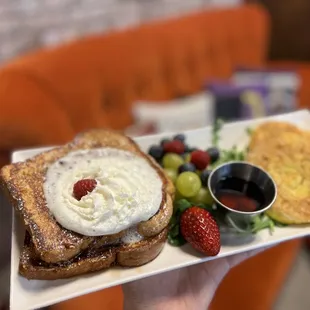 a plate of french toast and fruit