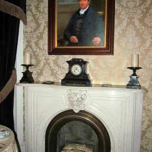 This gorgeous first floor fireplace is watched over by one of the home's ancestors.