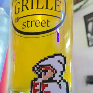 a glass of beer and a pin