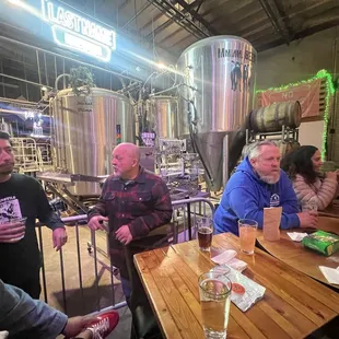 Fermentation tanks, people, beer, tables