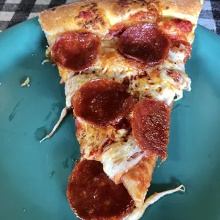 Slice of large pepperoni pizza
