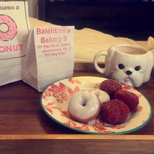 a plate of donuts and a cup of coffee
