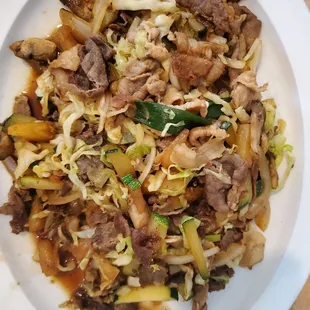 Stir fry with pork, beef, cabbage, onion, mushroom, zucchini, pineapple, house sauce. Rice is included on the side.