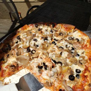 a pizza with mushrooms and olives