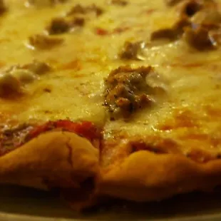 The crust, one piece of sausage on the right slice