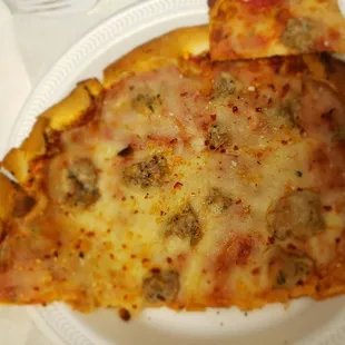 No sausage on the lower left of the pizza