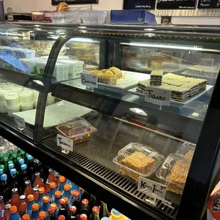 a display case with a variety of baked goods