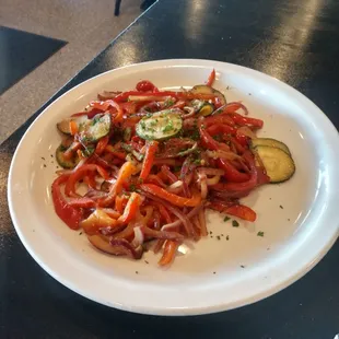 Cooked sweet peppers and zucchini with paprika as a side dish (mixed vegetables)