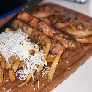 grilled meat and fries on a cutting board