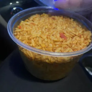 a person pouring water into a bowl of rice