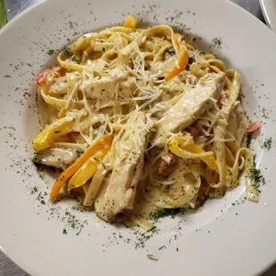 a plate of pasta with chicken and vegetables