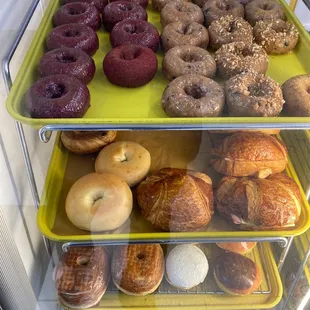 a variety of doughnuts in a display case