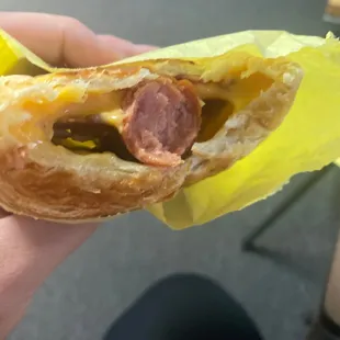 a person holding a hot dog