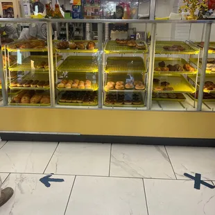 a person standing in front of a bakery