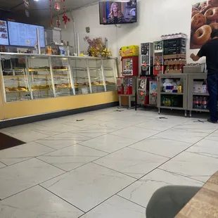 a man standing in a donut shop
