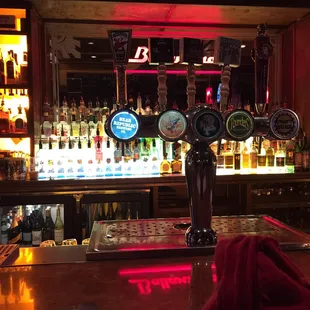 a bar with a row of beer taps