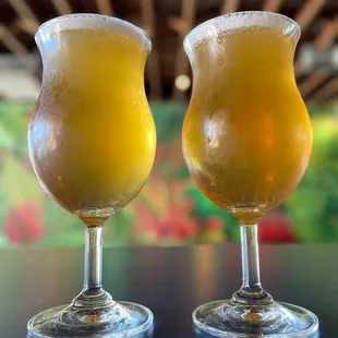 two glasses of beer on a table