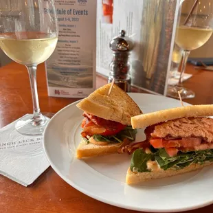 a sandwich and a glass of wine