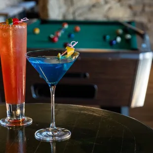 Drinks in game room with pool table, cocktails.