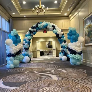 Whimsical organic cloud pillars with grand entrance walkthrough arch. Loving the colors to
match their logo.