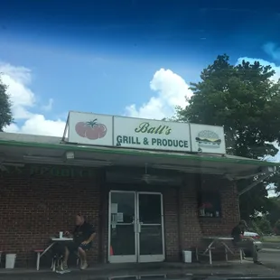 a man sitting outside of a restaurant
