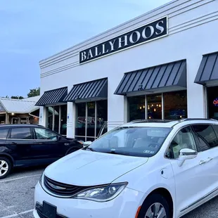 a white minivan parked in a parking lot