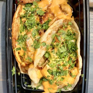 Overhead view of the Grilled Chicken Taco on the Roti Canai Flatbread with the Smoked Sriracha Sauce