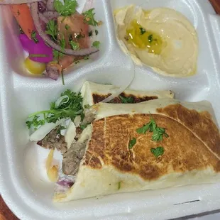 Lamb gyro sandwich with hummus and veggies