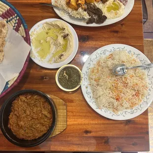 a wooden table with plates of food