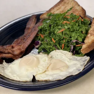 A breakfast plate featuring basted eggs, bacon and a heart healthy salad