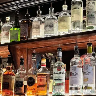 a shelf full of liquor bottles