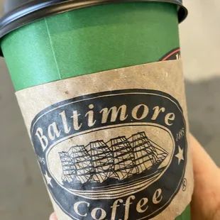 a hand holding a cup of coffee