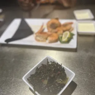 a plate of shrimp and greens