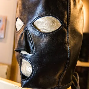 a leather mask on a shelf