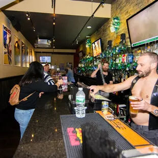 a man pouring a drink at a bar