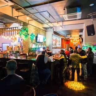 a large group of people sitting at a bar