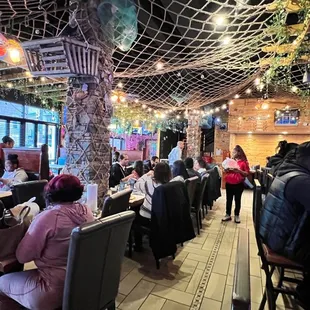 people sitting at tables in a restaurant