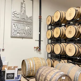 a man standing in front of barrels
