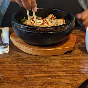 a person eating a bowl of food