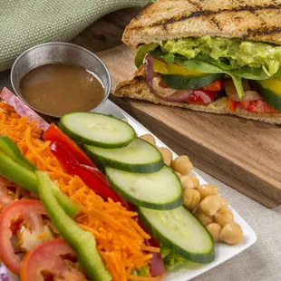a grilled sandwich and a salad